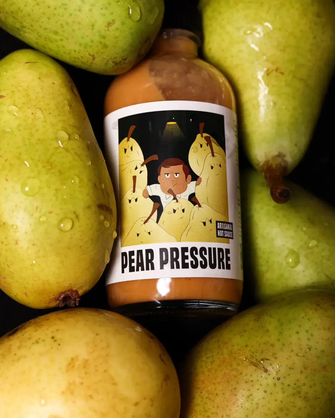 Pear Pressure bottle surrounded by fresh green pears