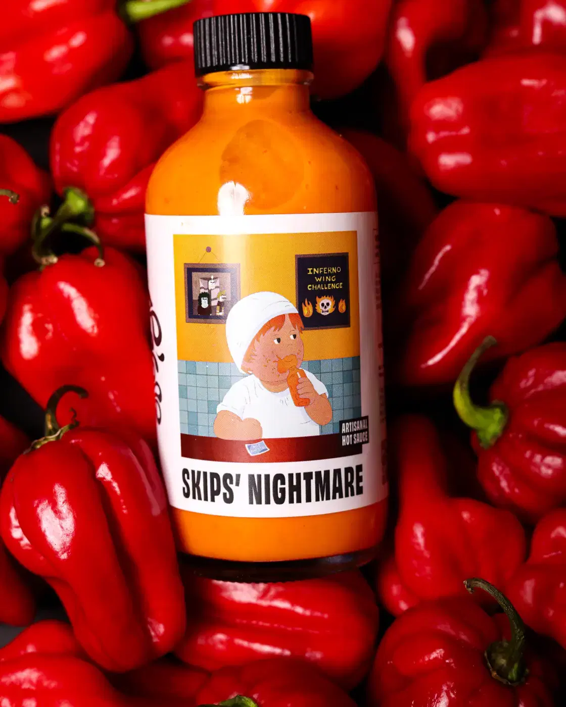 Skips' Nightmare bottle nested in a pile of red peppers