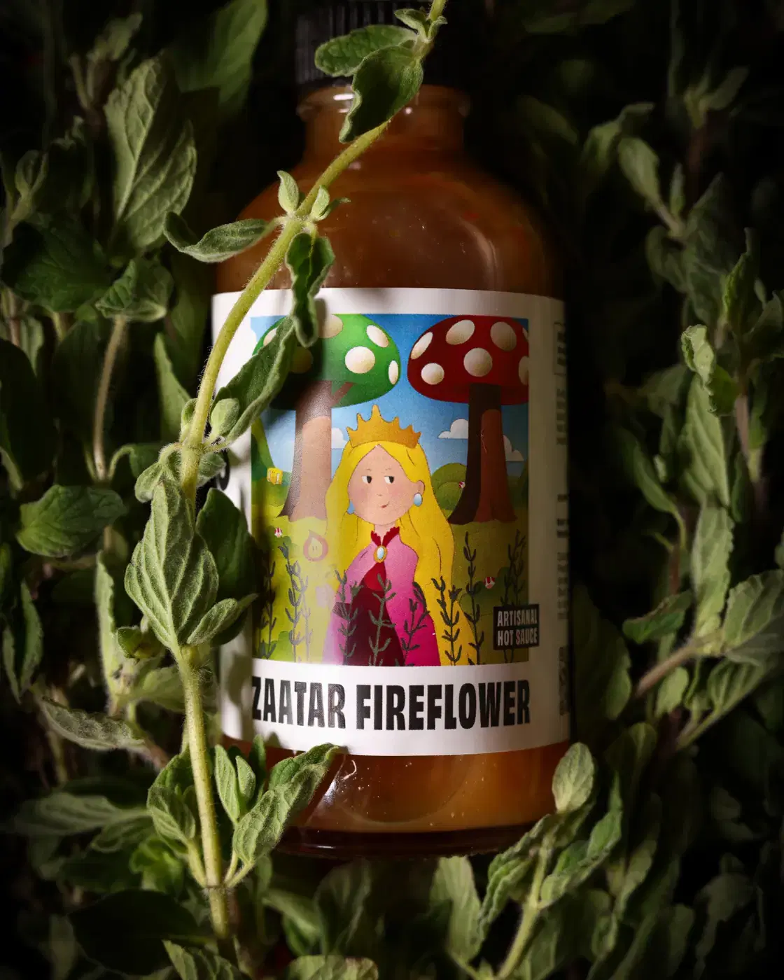 Zaatar Fireflower bottle lying in a bed of fresh zaatar